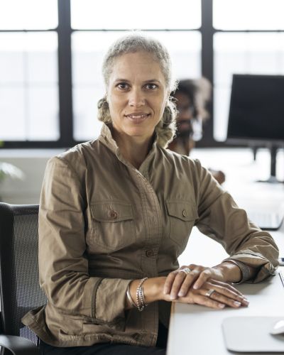 Portrait of mature businesswoman sitting at computer